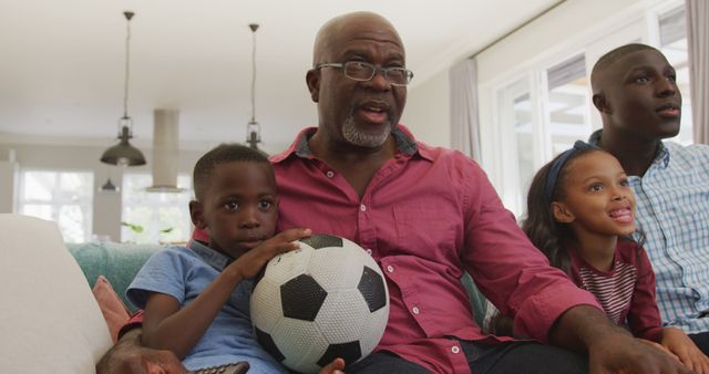 Grandfather Watching Soccer Match with Grandchildren on Couch - Download Free Stock Images Pikwizard.com