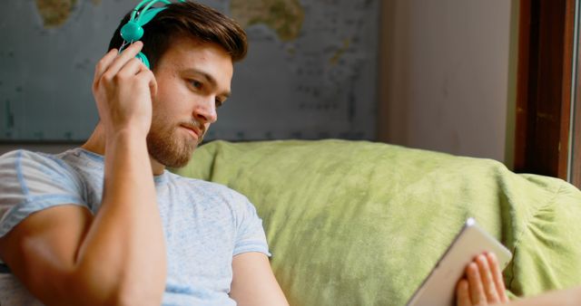 Young Man Listening to Music on Tablet with Headphones - Download Free Stock Images Pikwizard.com