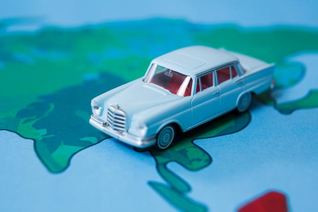 This image depicts a miniature classic car placed on a colorful map, symbolizing travel, journey, and adventure. It is ideal for use in articles or advertisements related to travel planning, road trips, navigation, tourism, and transportation services. The vibrant colors and the nostalgic car can attract viewers' attention and evoke a sense of excitement and curiosity about exploring new destinations.