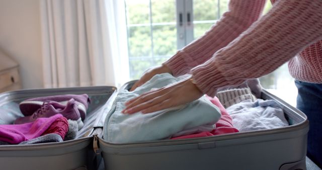 Person Packing Clothes in Suitcase Preparing for Trip - Download Free Stock Images Pikwizard.com