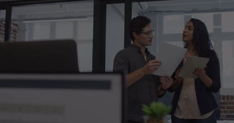 Business Professionals Discussing Financial Data in Modern Office