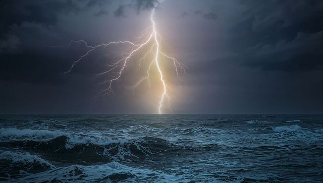 Dramatic lightning thunderstorm over ocean at night
