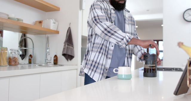 Man preparing morning coffee in stylish modern kitchen - Download Free Stock Images Pikwizard.com