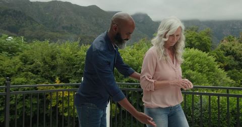 Couple sharing romantic moment on serene balcony surrounded by nature