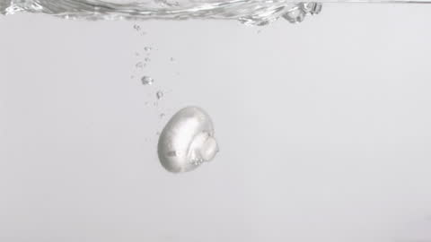 Mushroom Plunging into Water in Slow Motion with Air Bubbles
