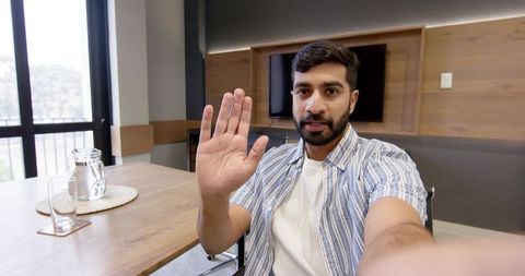Professional man engaging in online meeting office environment