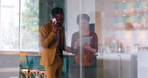 Colleagues Collaborating on Digital Project in Modern Office