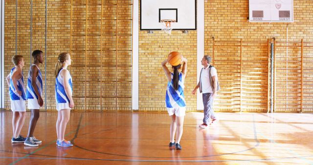 Mixed Gender Basketball Team Practicing in Gymnasium - Download Free Stock Images Pikwizard.com