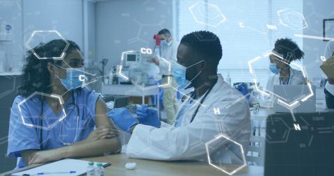 Diverse Doctor Administering Vaccination in High-Tech Setting - Download Free Stock Images Pikwizard.com