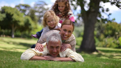 Happy Family Enjoying Time at Park with Playful Interaction
