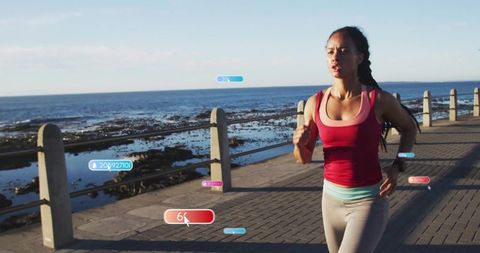 Woman running on coastal promenade with hud fitness overlays tracking pace and heart rate