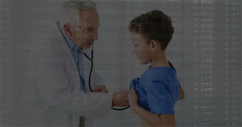 Doctor Examining Boy with Stethoscope in Clinic