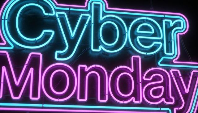 Glowing cyber monday neon sign in cyan and magenta showing tubing, clips and wires