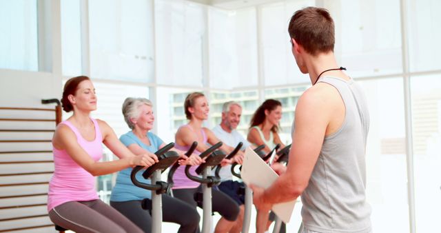 Fitness Instructor Leading Spin Class in Modern Gym - Download Free Stock Images Pikwizard.com