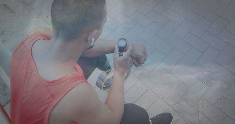 Young Fit Man Checking Smartwatch for Fitness Tracking Outdoors