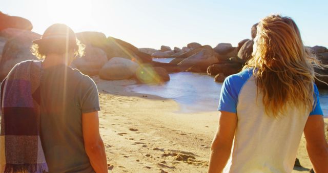 Friends Walking on Sandy Beach During Sunset - Download Free Stock Images Pikwizard.com