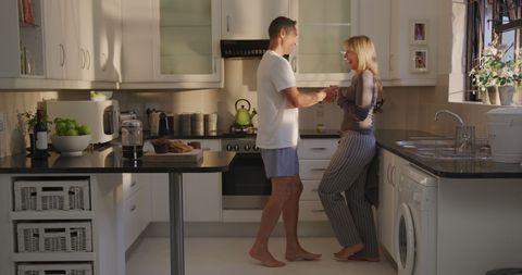 Happy Couple Enjoying Morning Coffee in Modern Kitchen