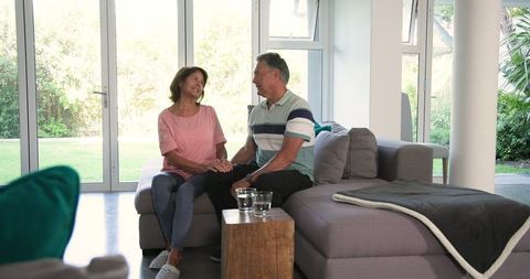 Senior Couple Relaxing and Bonding on Sofa at Home