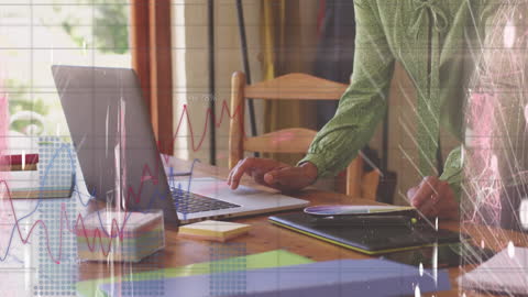 Financial Data Analytics Overlaid with Businessman Using Laptop in Office
