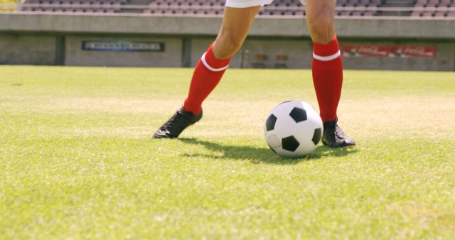 Football player dribbling the ball on the football ground - Download Free Stock Photos Pikwizard.com