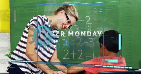 Teacher Guiding Young Student with Math on Chalkboard