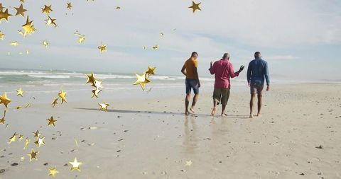 Three friends walking on beach leaving footprints with gold star overlay and calm seascape