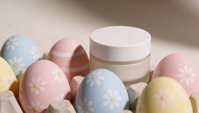 Frosted skincare jar nestling in egg carton with pastel daisy eggs for spring mockup