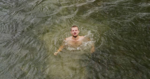 Man Swimming in Murky Outdoor Water - Download Free Stock Photos Pikwizard.com