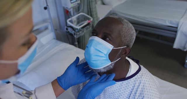 Healthcare Worker Treating Senior Patient in Hospital with Mask - Download Free Stock Images Pikwizard.com