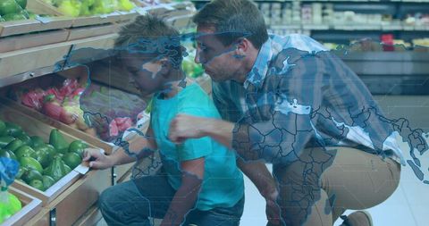 Father and son selecting avocados in grocery store with world map overlay, family bonding