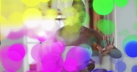 Standing woman in towel holding skincare jar with pastel bokeh lights for selfcare