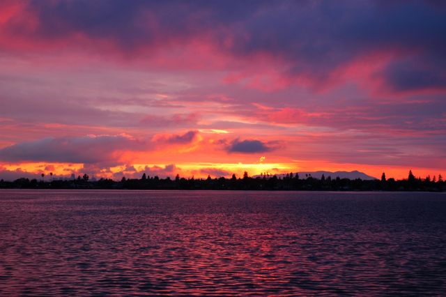 Stunning Sunset over Calm Lake with Colorful Sky - Download Free Stock Photos Pikwizard.com