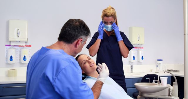 Patient in Dental Chair Receiving Treatment from Dentist and Assistant - Download Free Stock Images Pikwizard.com