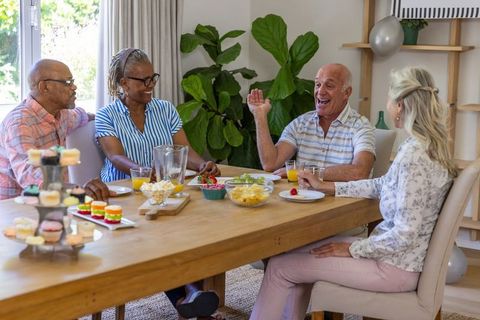 Diverse Senior Friends Enjoying Social Gathering in Welcoming Dining Room