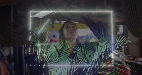 Mechanic inspecting car engine with futuristic neon overlay