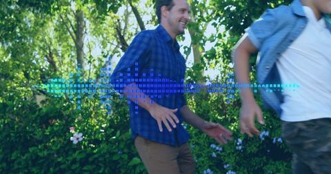 Smiling father playing with child in backyard with blue digital audio waveform overlay
