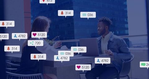 Checking notifications and tracking engagement metrics while collaborating on rooftop laptop
