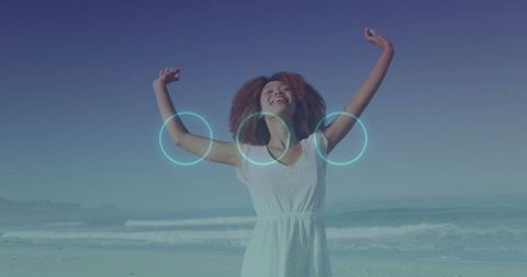 Joyful Woman Celebrating on Beach in White Sundress
