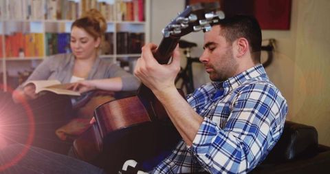 Man Relaxing with Guitar in Cozy Living Room