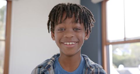 Smiling Boy with Braided Hair Standing by Window - Download Free Stock Images Pikwizard.com