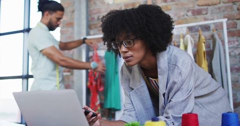 Fashion designers collaborating in trendy loft studio