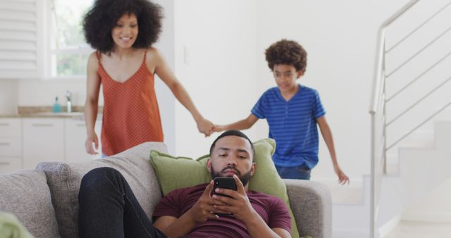 Father Relaxing on Sofa with Family in Bright Living Room - Download Free Stock Images Pikwizard.com