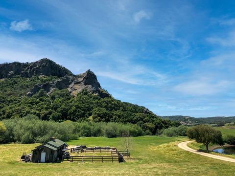 Rustic Cabin on Serene Mountain Landscape with Dirt Path
