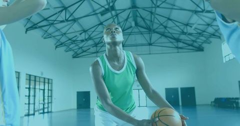 Female Basketball Player Preparing Jump Shot Holding Ball Focusing on Hoop