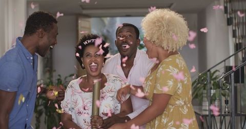 Joyful celebration with friends and party poppers at home