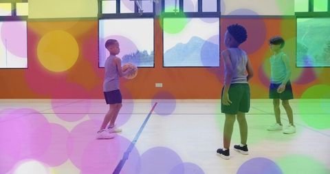 Children Playing Basketball in Colorful Gymnasium