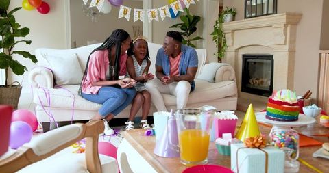 Joyful Family Celebrating Child's Birthday with Party Decorations