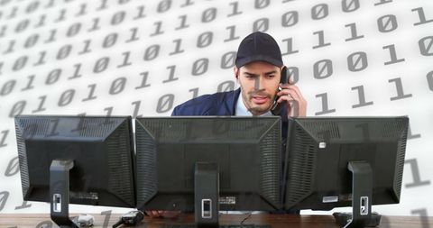 Man managing multiple computer screens research project