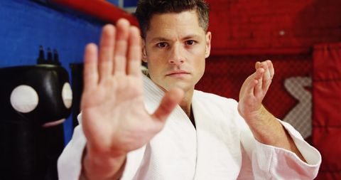 Focused Martial Artist Demonstrating Karate Techniques