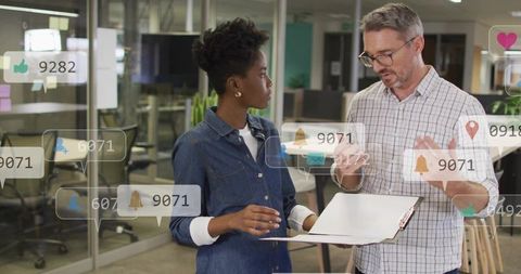 Colleagues discussing project with augmented reality notifications in modern office